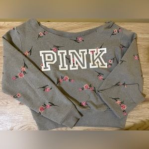 Off-shoulder PINK sweater.